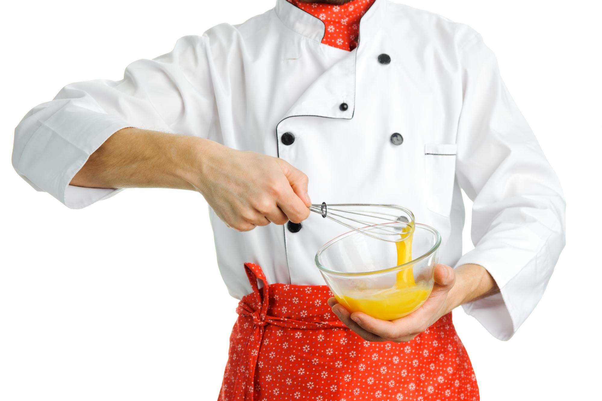 Chef demonstrating fast cooking technique in a bright kitchen